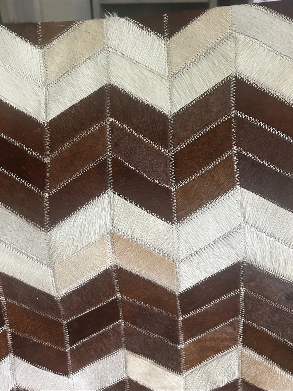 Cowhide Chevron Patchwork Throw Pillow Cover with genuine leather back.